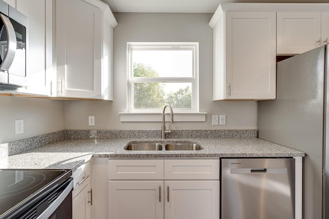 kitchen with white cabinetry, sink, and stainless steel appliances