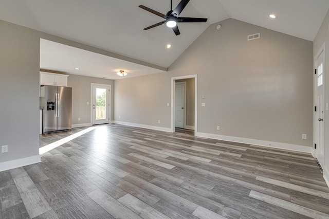 unfurnished living room with high vaulted ceiling, ceiling fan, and light hardwood / wood-style flooring