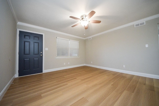 foyer featuring light wood-type flooring, ceiling fan, and crown molding