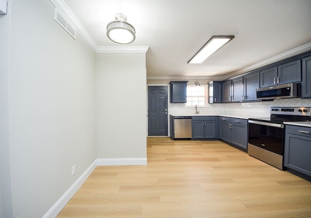 kitchen featuring stainless steel appliances, light wood-type flooring, ornamental molding, and tasteful backsplash