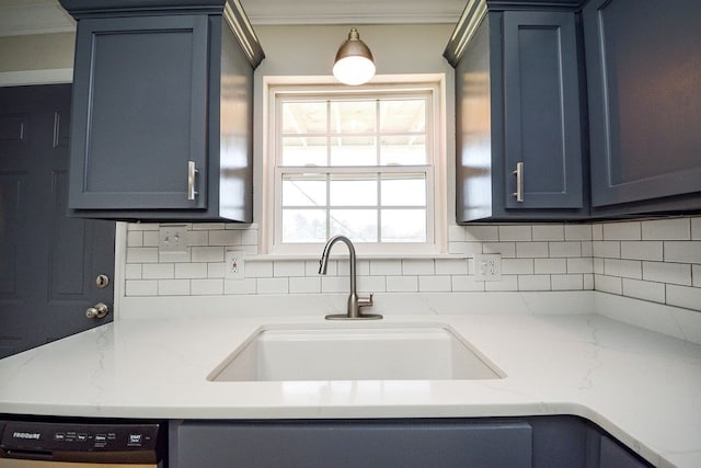 kitchen featuring blue cabinetry, dishwasher, sink, and tasteful backsplash