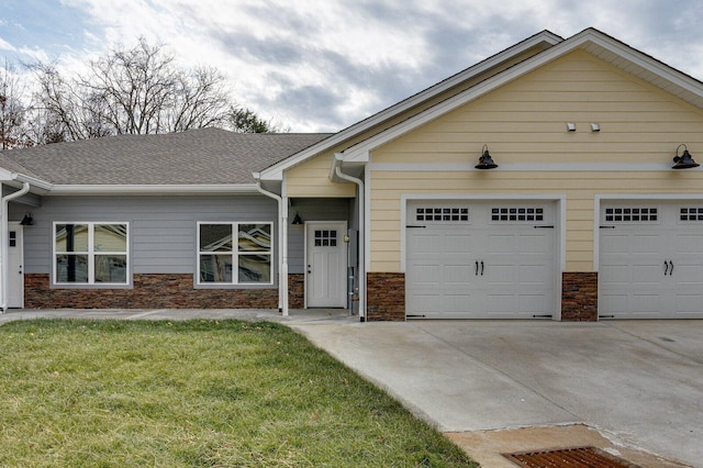 view of front of home featuring a garage and a front lawn