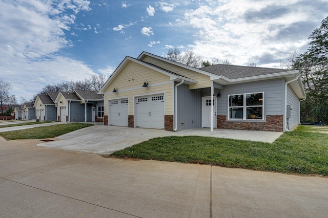 view of front of house featuring a garage and a front lawn