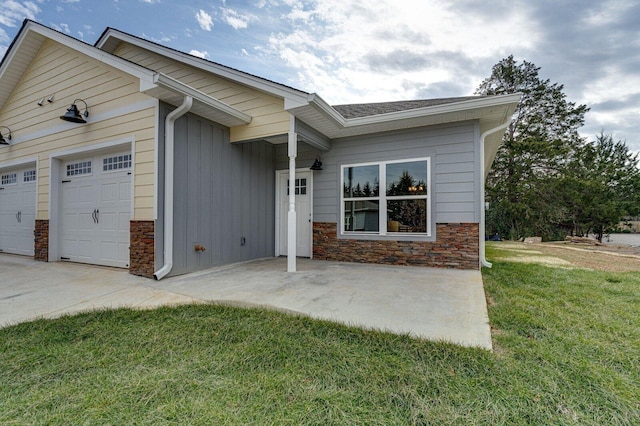 single story home with a garage and a front lawn