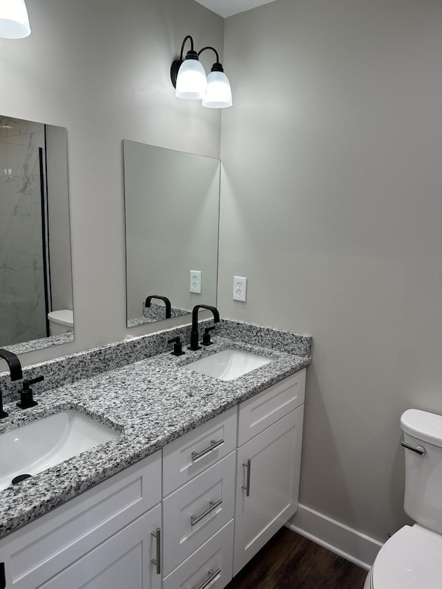 bathroom featuring vanity, a shower, toilet, and wood-type flooring