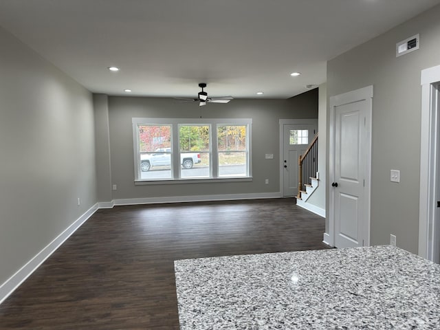 unfurnished living room with ceiling fan and dark hardwood / wood-style flooring