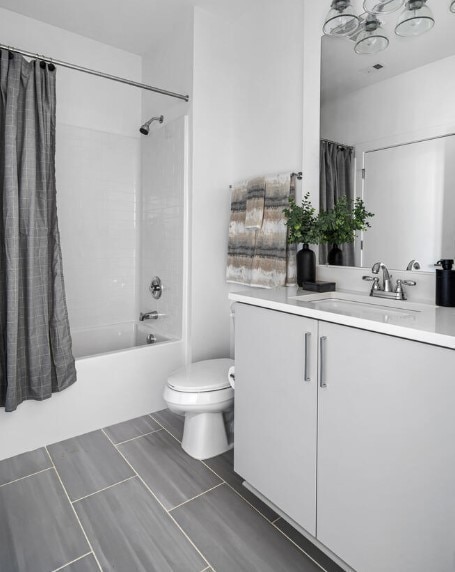 full bathroom featuring vanity, shower / bath combo with shower curtain, and toilet