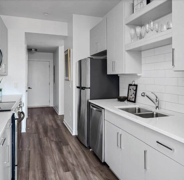 kitchen featuring white cabinets, sink, appliances with stainless steel finishes, and dark wood-type flooring