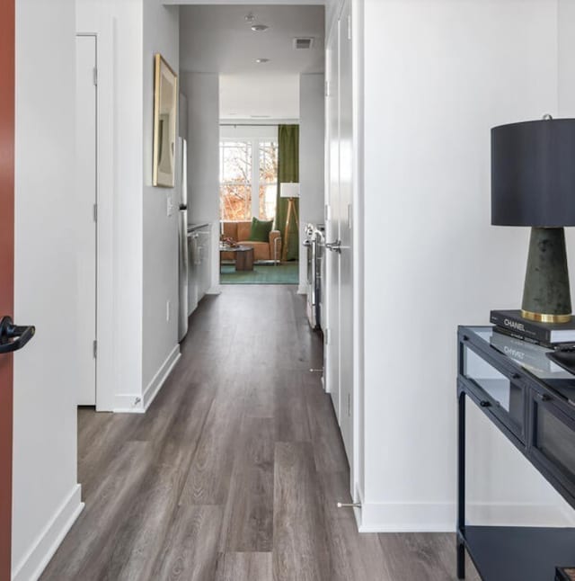 hallway with dark wood-type flooring