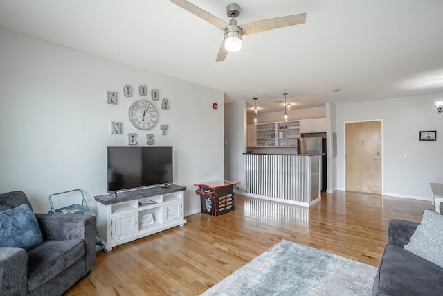 living room featuring ceiling fan and light wood-type flooring