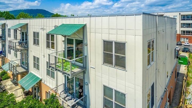 view of side of home with a mountain view