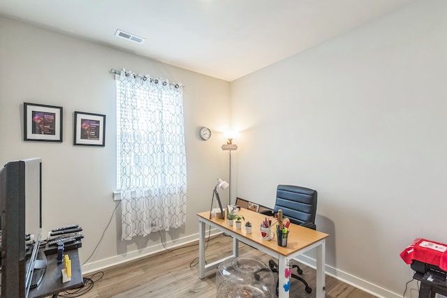 home office with wood-type flooring