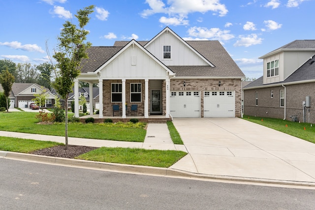 view of front facade with a front lawn, a porch, and a garage