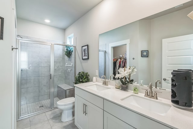 bathroom featuring tile patterned floors, walk in shower, vanity, and toilet