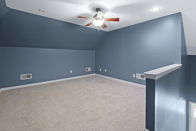 bonus room with light carpet, vaulted ceiling, and ceiling fan