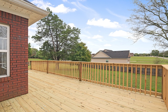 wooden deck featuring a yard