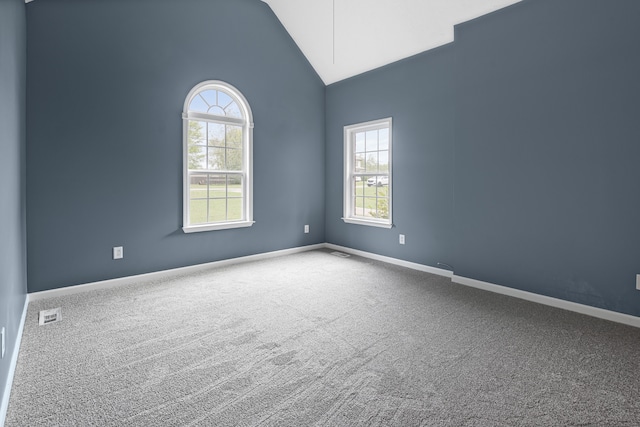 unfurnished room with carpet floors, high vaulted ceiling, and a healthy amount of sunlight