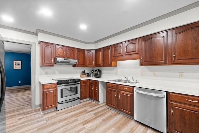 kitchen with appliances with stainless steel finishes, light wood-type flooring, sink, and crown molding