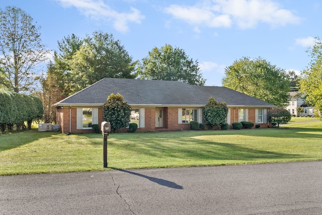 single story home with a front lawn