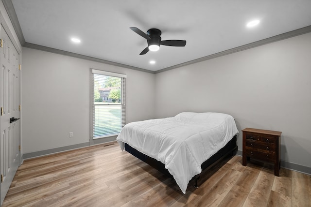 bedroom featuring wood-type flooring, ornamental molding, and ceiling fan