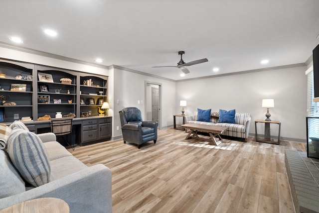 living room featuring ceiling fan, light wood-type flooring, crown molding, and built in desk