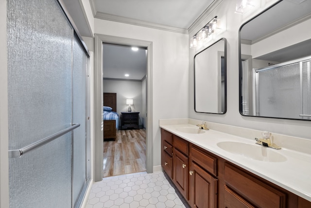 bathroom with ornamental molding, vanity, hardwood / wood-style floors, and a shower with door