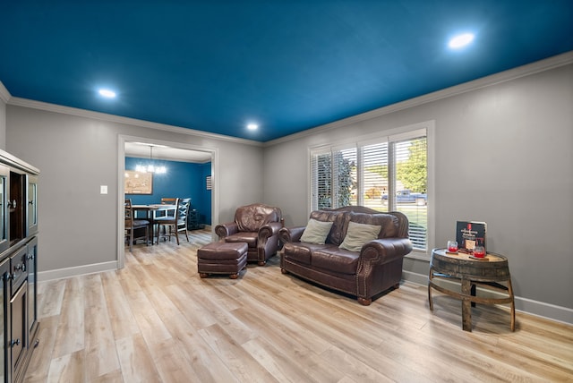 living room with an inviting chandelier, light wood-type flooring, and crown molding