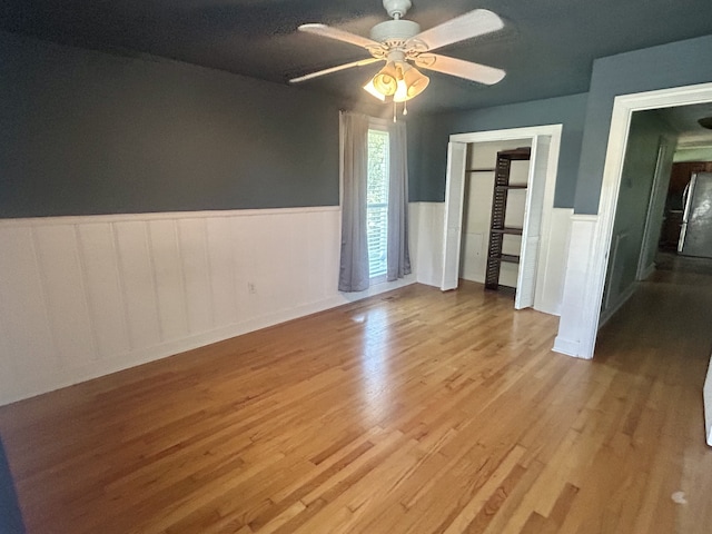 empty room featuring ceiling fan and light hardwood / wood-style flooring