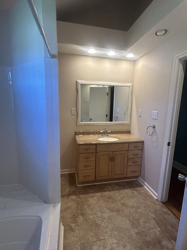 bathroom with vanity and a bathtub