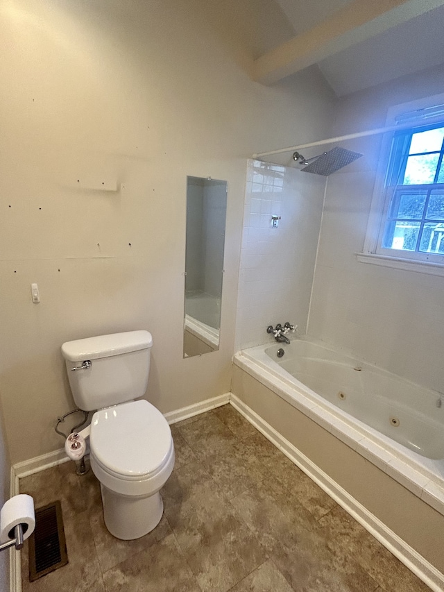 bathroom featuring tiled shower / bath and toilet