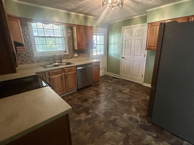 kitchen with a healthy amount of sunlight, ornamental molding, sink, and stainless steel appliances