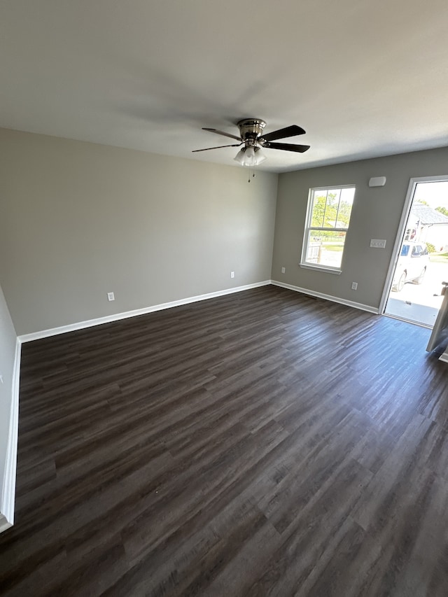 spare room featuring dark hardwood / wood-style floors and ceiling fan