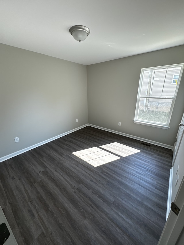 empty room with dark hardwood / wood-style floors