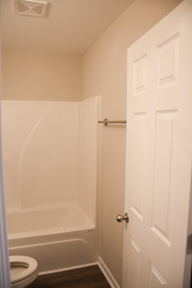 1603 Mantlo St, Springfield, TN 37172 - bathroom featuring toilet, bathing tub / shower combination, wood finished floors, and baseboards