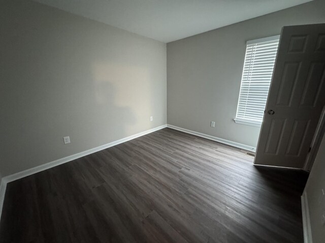 1603 Mantlo St, Springfield, TN 37172 - unfurnished bedroom featuring dark wood-style flooring and baseboards