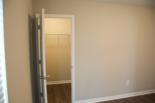 1603 Mantlo St, Springfield, TN 37172 - unfurnished bedroom featuring dark wood finished floors, baseboards, a closet, and a spacious closet