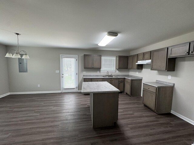 1603 Mantlo St, Springfield, TN 37172 - kitchen featuring a sink, under cabinet range hood, a kitchen island, baseboards, and dark wood-type flooring