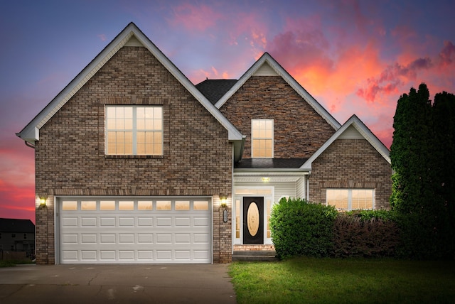 traditional home with a garage, driveway, and brick siding