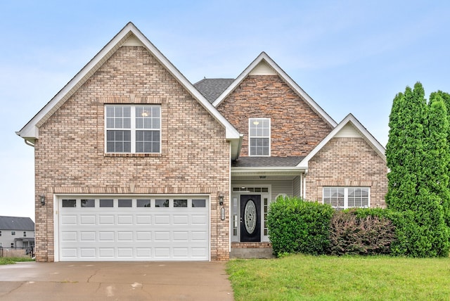 traditional-style house featuring a garage, driveway, brick siding, and a front lawn