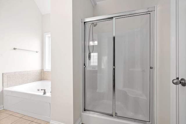 bathroom with tile patterned floors, lofted ceiling, and independent shower and bath