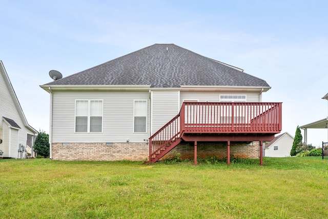 rear view of property with a shingled roof, crawl space, a lawn, and a deck