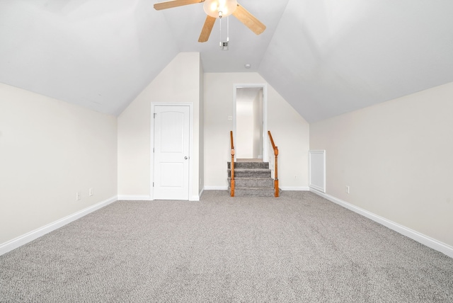 bonus room with baseboards, a ceiling fan, lofted ceiling, carpet, and stairs