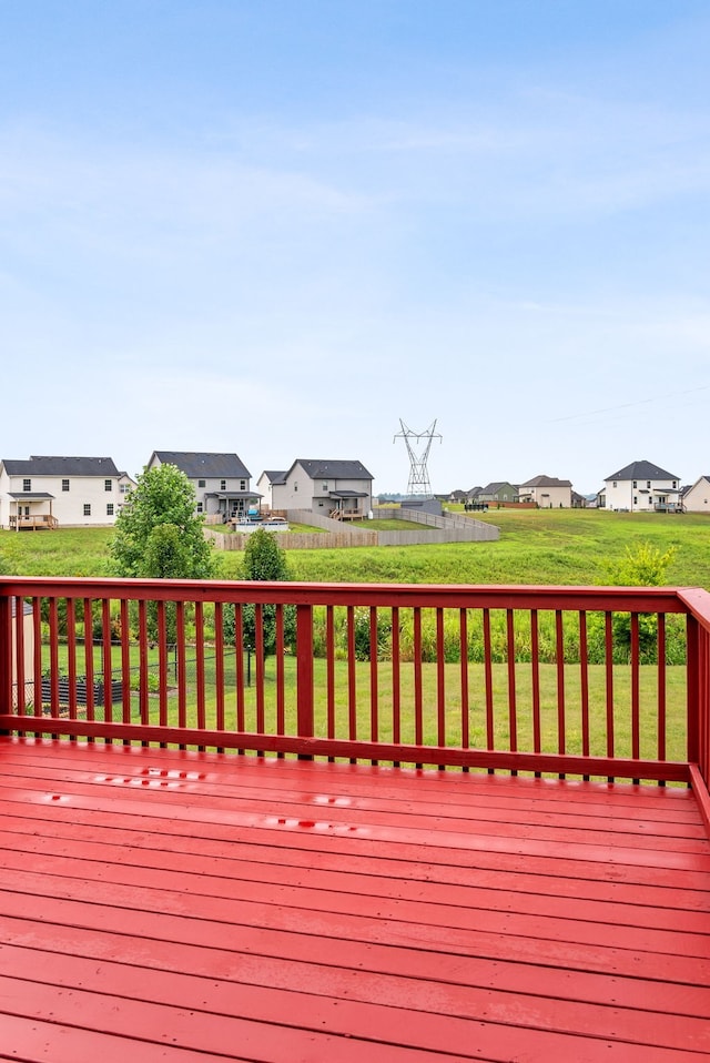 wooden terrace with a yard and a residential view