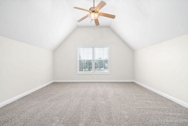 additional living space with vaulted ceiling, carpet floors, a ceiling fan, and baseboards