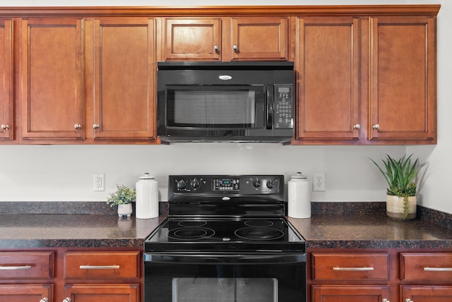 kitchen featuring black appliances and dark stone counters