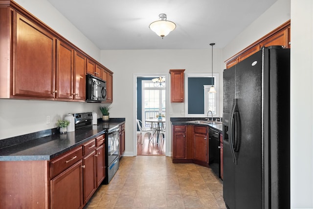 kitchen with sink, decorative light fixtures, and black appliances