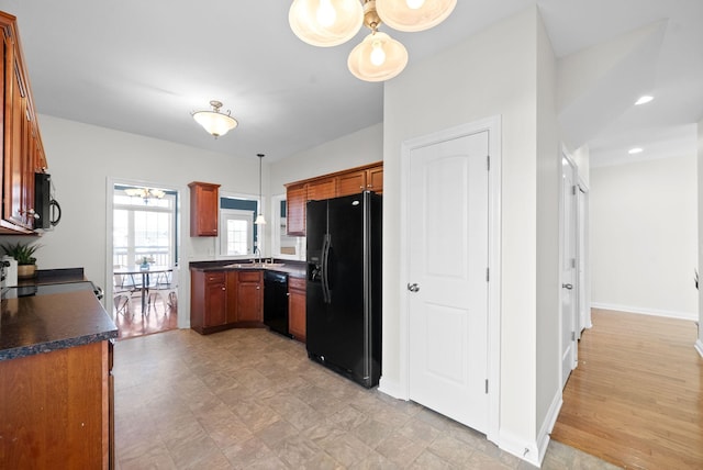 kitchen featuring black appliances, pendant lighting, and sink