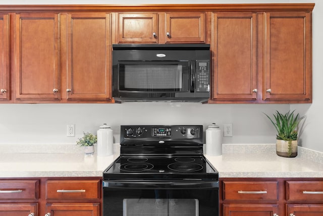 kitchen with light countertops and black appliances