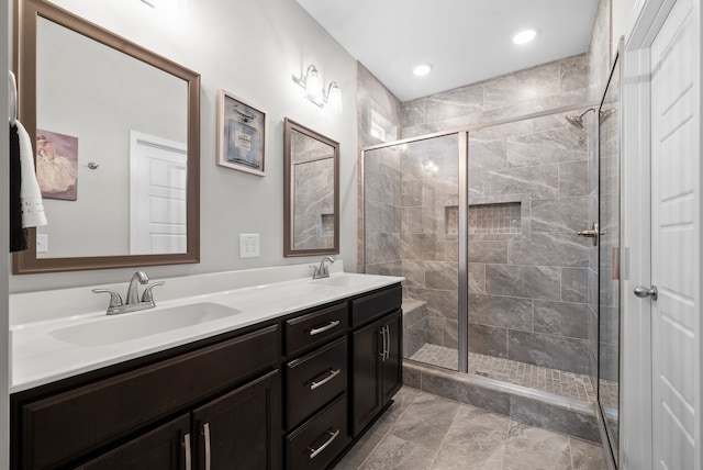 bathroom with a shower with shower door and vanity