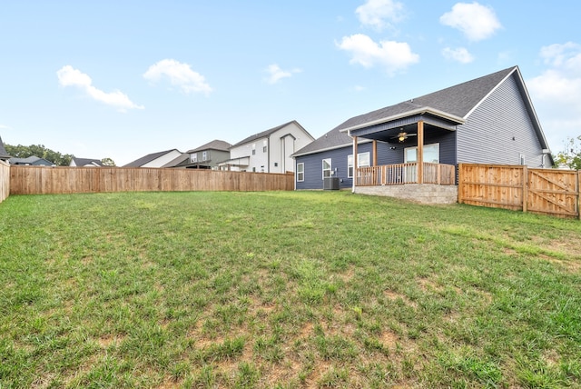 view of yard featuring a patio, ceiling fan, and central air condition unit